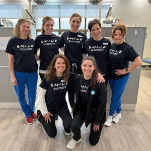 ABC Dentistry team members smiling together in the clinic reception area