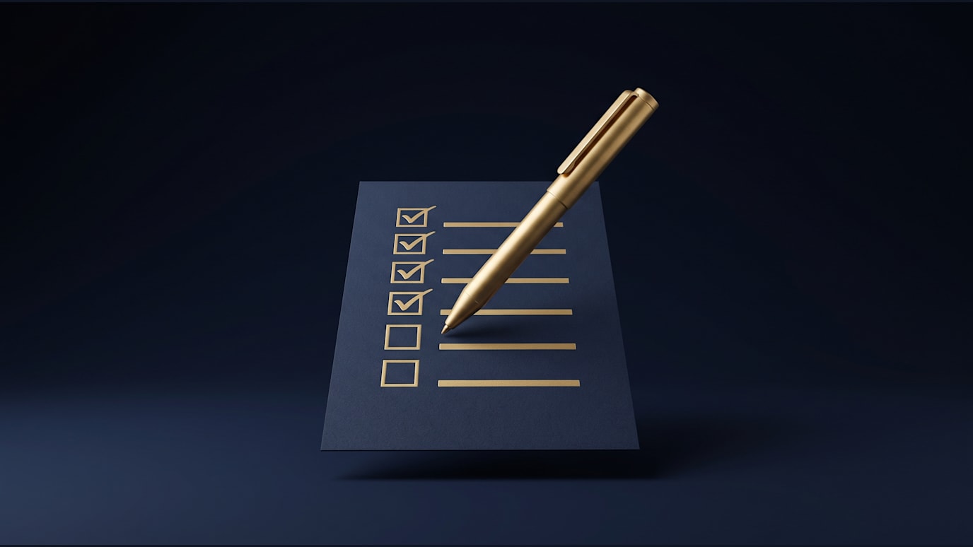 A checklist is being ticked line by line with a gold pen hovering over the next mark