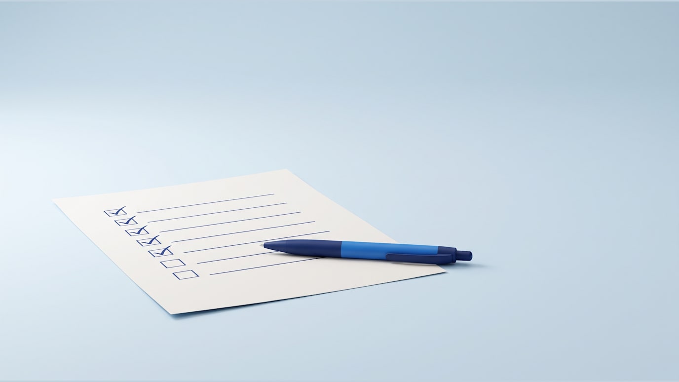 A checklist is being marked complete while a blue pen rests on the next empty line
