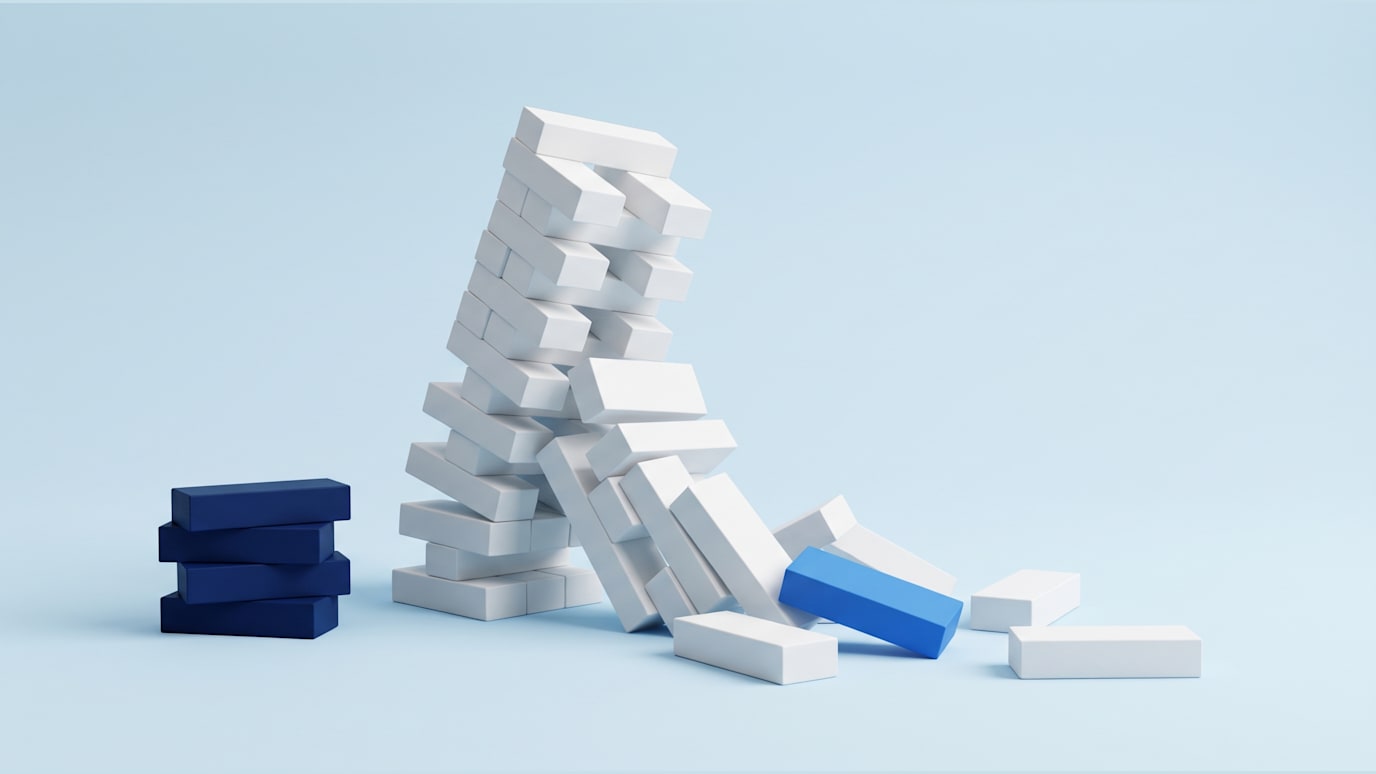A tall stack of white blocks tipping over and falling apart