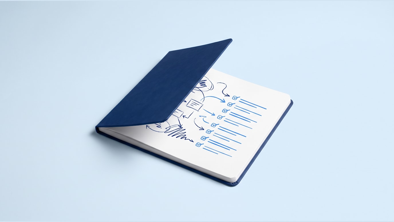 A notebook is being opened to a page where rough meeting notes are becoming checked action lines