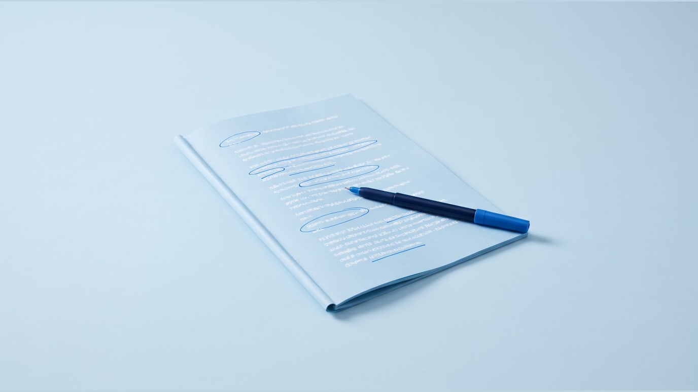 A printed script is being marked up with a blue pen as lines are circled for recording