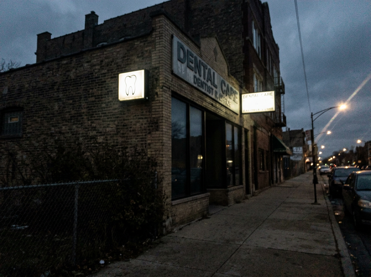 Dark blurry unedited phone photo of a business storefront